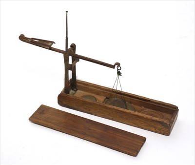 Lot 1087 - A walnut cased coin scale