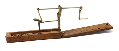 Lot 1102 - A mahogany cased brass folding coin scale