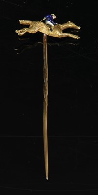Lot 101 - A gold and enamel jockey on horseback stick pin