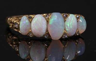 Lot 69 - A Victorian gold five stone opal carved head ring