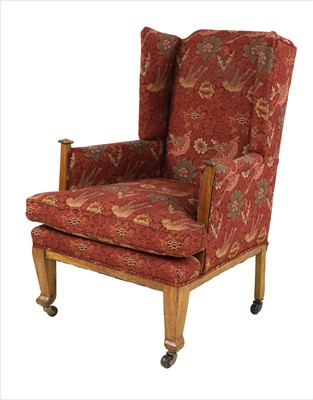 Lot 90 - An Arts & Crafts oak wing back armchair