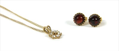 Lot 58 - A pair of gold cabochon garnet stud earrings
