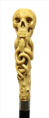 Lot 185 - A carved ivory skull and snake walking stick