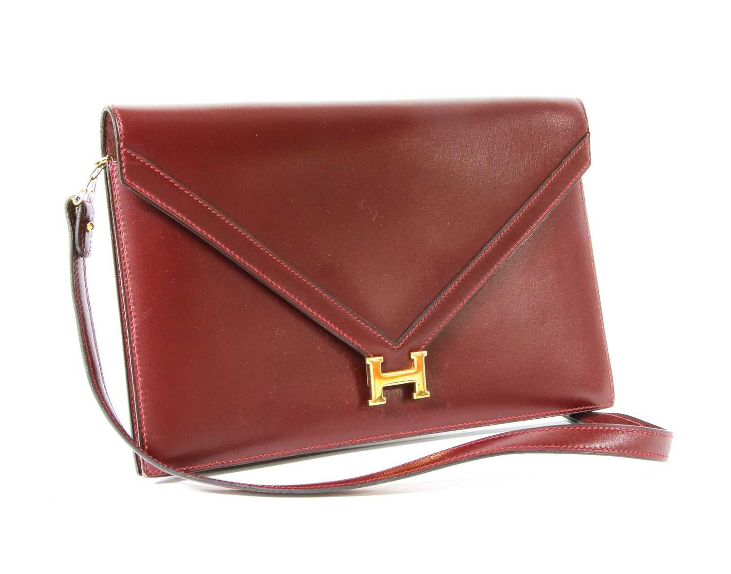 Lot 417 - An Hermès 'Lydie' red clutch bag
