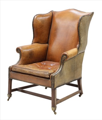 Lot 830 - A leather wing back armchair