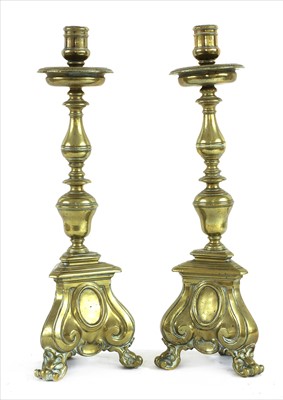 Lot 516 - A pair of cast brass candlesticks