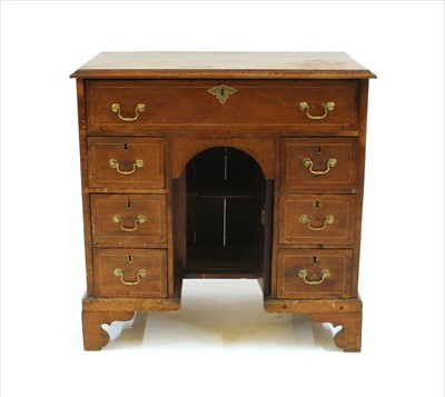 Lot 377 - A walnut kneehole desk