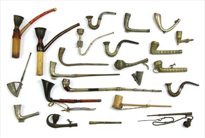 Lot 186 - Twenty-two Indian metal and wood-mounted pipes