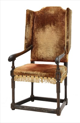 Lot 617 - A joined oak wing armchair