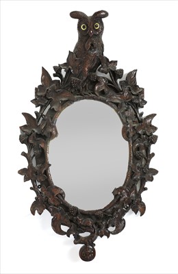 Lot 125 - A Black Forest carved wall mirror