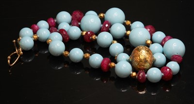 Lot 188 - A single row reconstituted turquoise, ruby and gold bead necklace