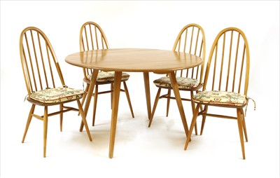 Lot 516 - An Ercol light elm dining suite