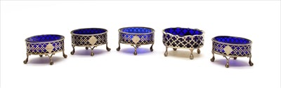 Lot 142 - Four George III silver salts with blue glass liners