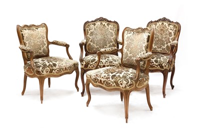 Lot 889 - A pair of French carved beech and parcel gilt framed open armchairs