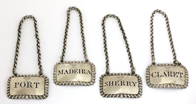 Lot 14 - A set of four George III silver wine labels
