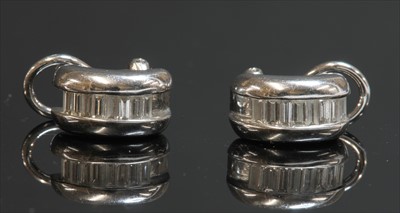 Lot 304 - A pair of 18ct white gold diamond set half hoop or cuff earrings