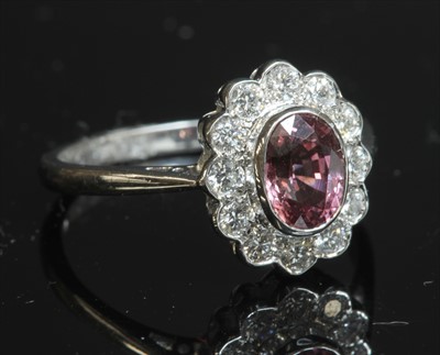 Lot 260 - An 18ct white gold sapphire and diamond oval cluster ring
