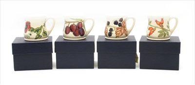 Lot 277 - A collection of four boxed Moorcroft mugs