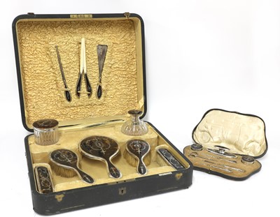 Lot 68 - A tortoiseshell and silver dressing table vanity set
