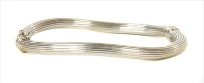 Lot 73 - An Italian 18ct white gold wave bangle