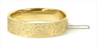 Lot 7 - A 9ct gold hollow hinged bangle