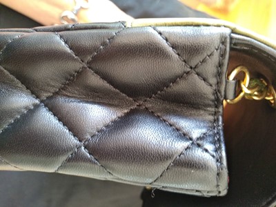 Lot 411 - A Chanel black lambskin petit flap bag