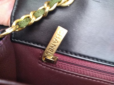 Lot 411 - A Chanel black lambskin petit flap bag