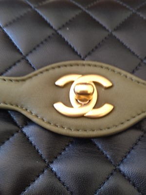 Lot 411 - A Chanel black lambskin petit flap bag