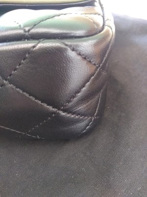 Lot 411 - A Chanel black lambskin petit flap bag