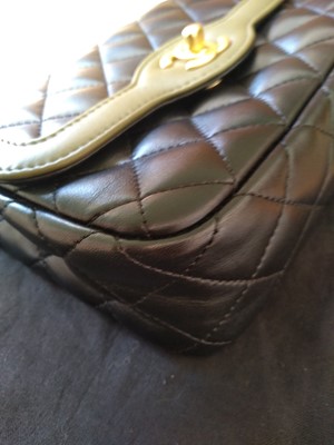 Lot 411 - A Chanel black lambskin petit flap bag