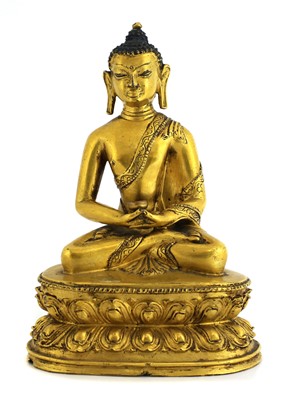 Lot 63 - A Tibetan gilt bronze Shakyamuni Buddha