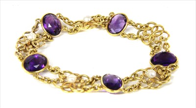Lot 31 - An Edwardian gold amethyst and pearl bracelet