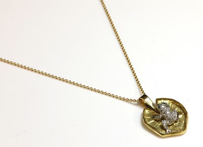 Lot 171 - An
American gold and platinum, diamond and emerald set frog pendant by S McTeigue