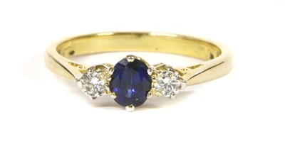 Lot 63 - An 18ct gold sapphire and diamond three stone ring