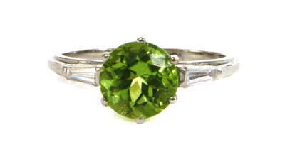 Lot 91 - A platinum peridot and diamond three stone ring