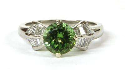 Lot 92 - A platinum peridot and diamond ring
