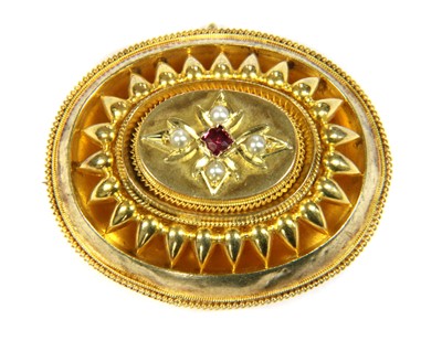 Lot 2 - A Victorian Etruscan Revival gold garnet and split pearl brooch