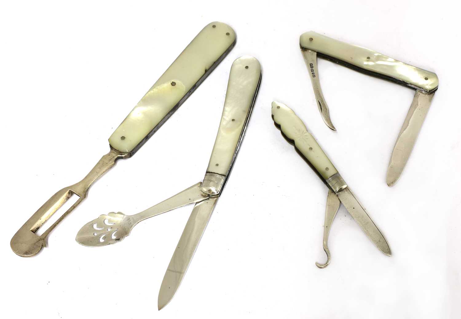 Lot 23 - Three silver and mother-of-pearl combination folding fruit knives