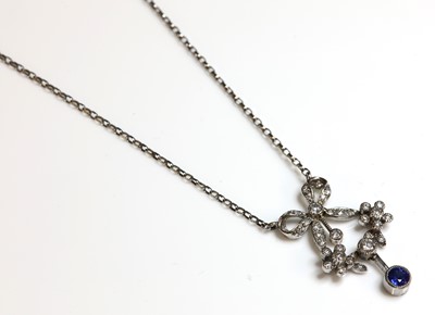 Lot 227 - A white gold Belle Époque-style sapphire and diamond swag pendant