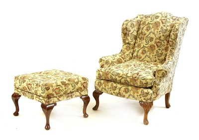 Lot 848 - A wing armchair and foot stool