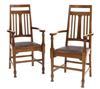 Lot 139 - A pair of Arts and Crafts oak elbow chairs