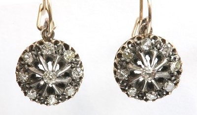 Lot 51 - A pair of Edwardian, diamond set, gold and silver cluster drop earrings, c.1910