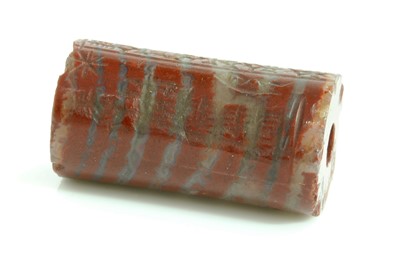 Lot 480 - A Babylonian red banded jasper cylinder seal