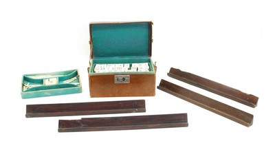 Lot 453 - A Chinese leather cased bamboo and bone Mahjong set