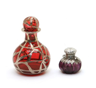 Lot 244 - A small amethyst glass and white metal scent bottle of squat form