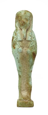 Lot 707 - A pale green faience shabti figure