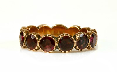Lot 19 - A Georgian foil-backed flat cut garnet eternity-style ring
