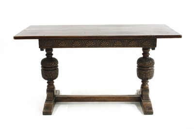 Lot 860 - An oak dining table