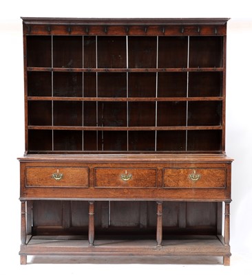 Lot 611 - A George III oak dresser with open pot board base and rack
