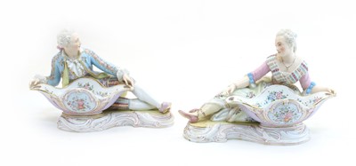 Lot 404 - A pair of Continental porcelain figural salts, one of a lounging dandy